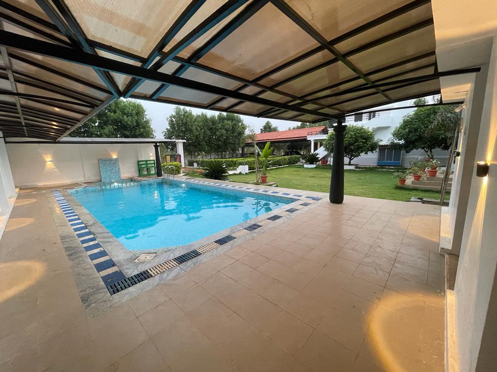 Outdoor swimming pool at Nellai Farm House in Tirunelveli