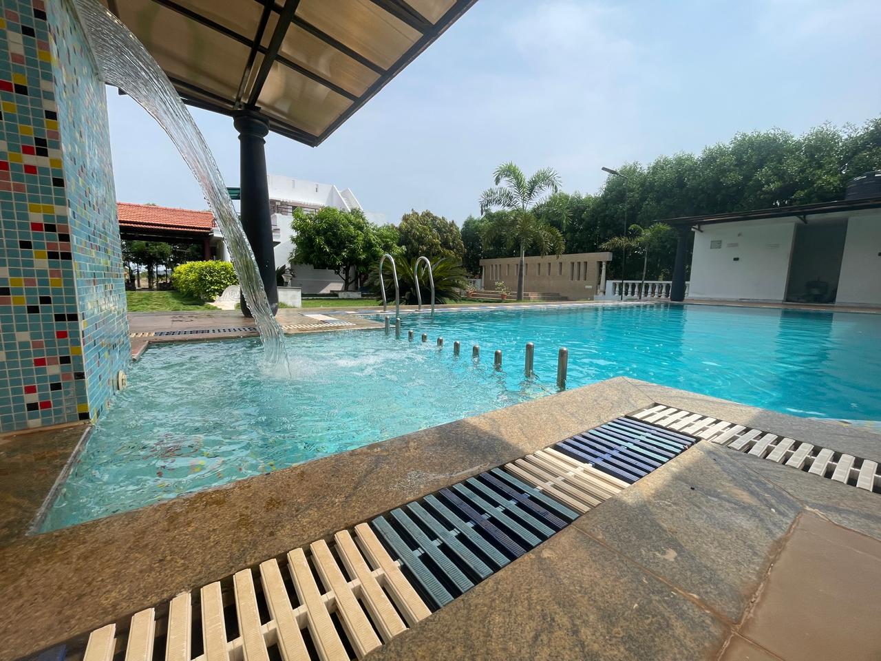 Relaxing poolside view at Nellai Farm House